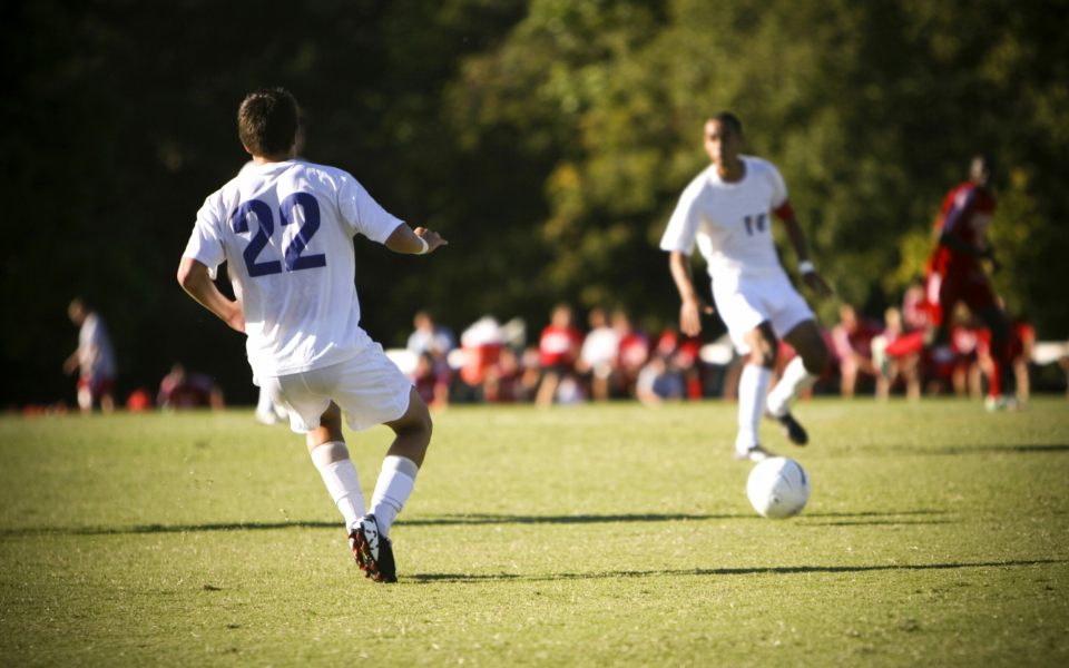 Soccer imagery with players in white uniforms